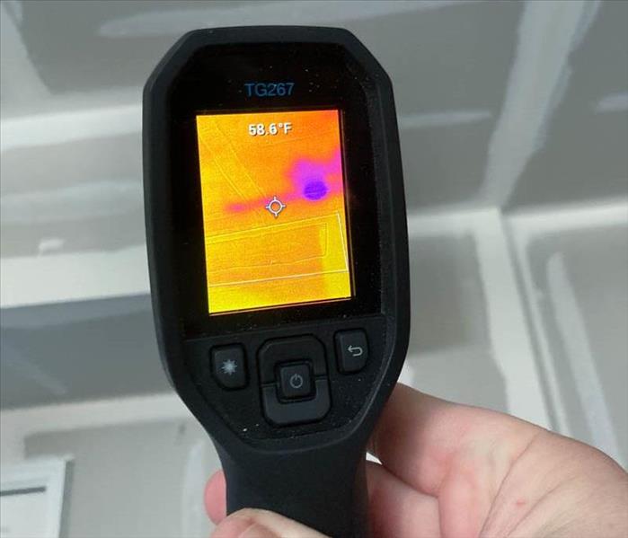 Thermal camera scanning a wall and ceiling.