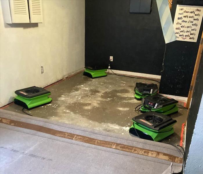 Drying equipment standing on bare floor.
