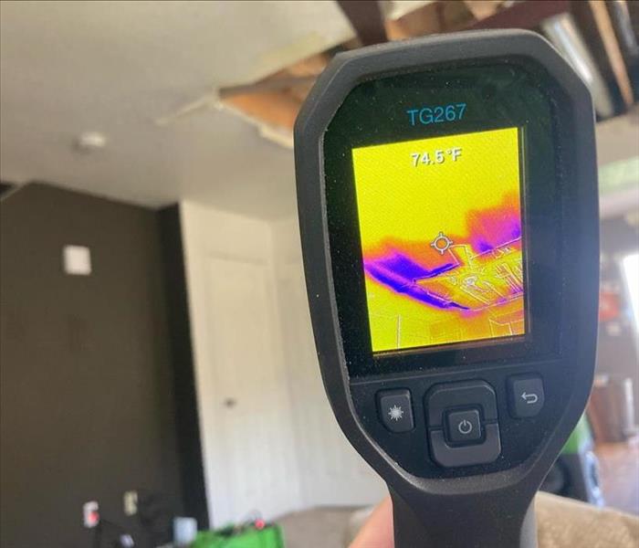 Thermal camera measuring moisture in the ceiling.