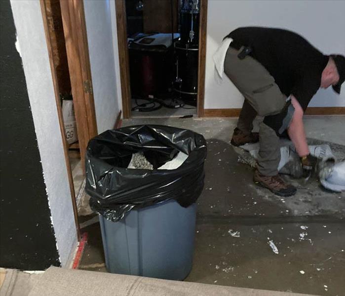 SERVPRO employee removing damaged materials